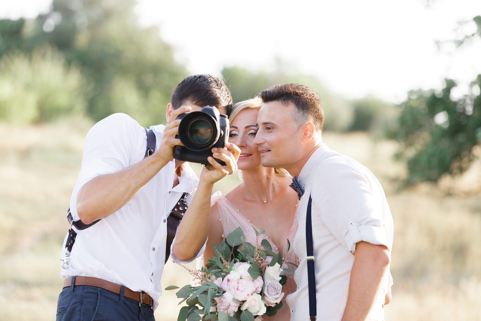 Wedding Photographer Takes Pictures Of Bride And Groom