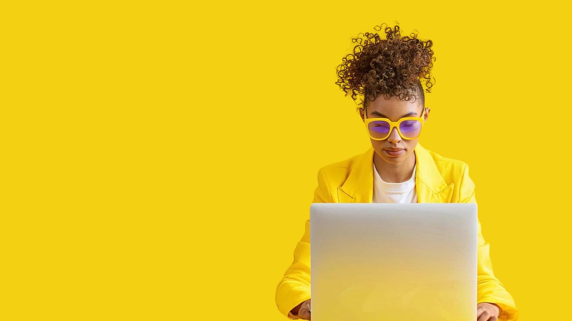 Black female working behind a laptop