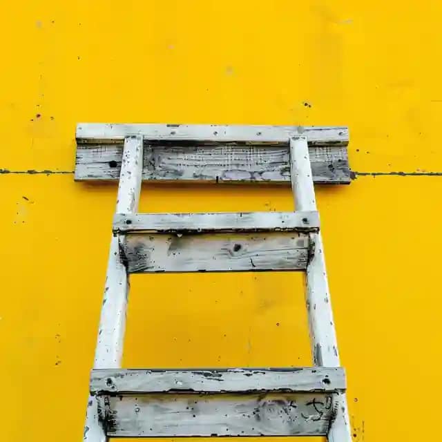 White Ladder On Yellow Background